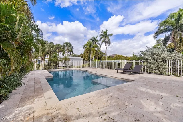 a view of a swimming pool with a lounge chairs