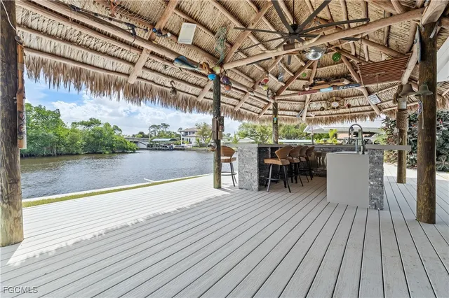 a view of a patio with dining table and chairs with wooden floor