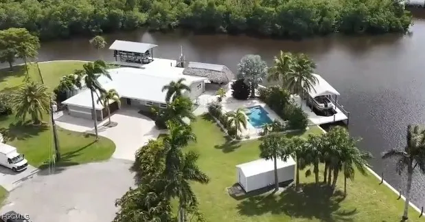 an aerial view of house with yard swimming pool and outdoor seating