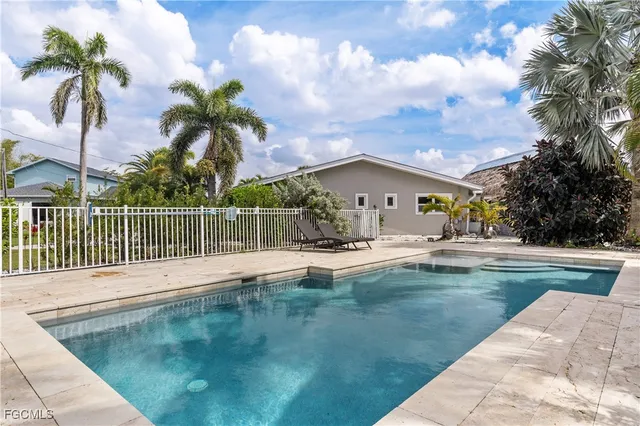 a view of a house with swimming pool and sitting area