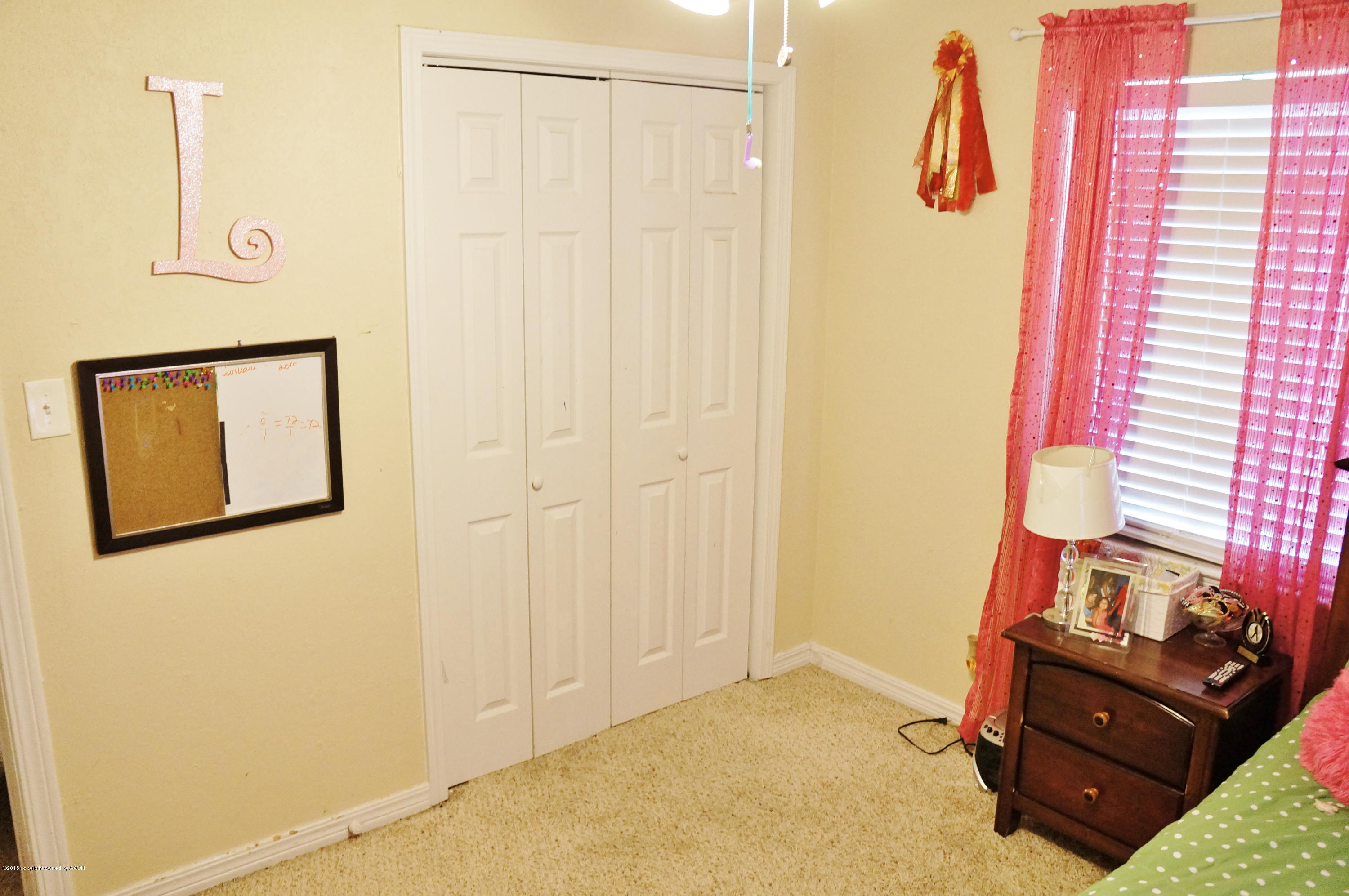 4207 Bowie Street Amarillo, TX 79110 - Photo 9 of 11 a bedroom with a bed and a dresser