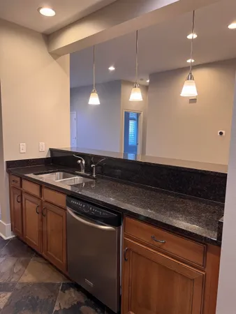 a kitchen with granite countertop a refrigerator and a stove