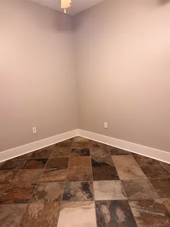 an empty room with an entrance to other room