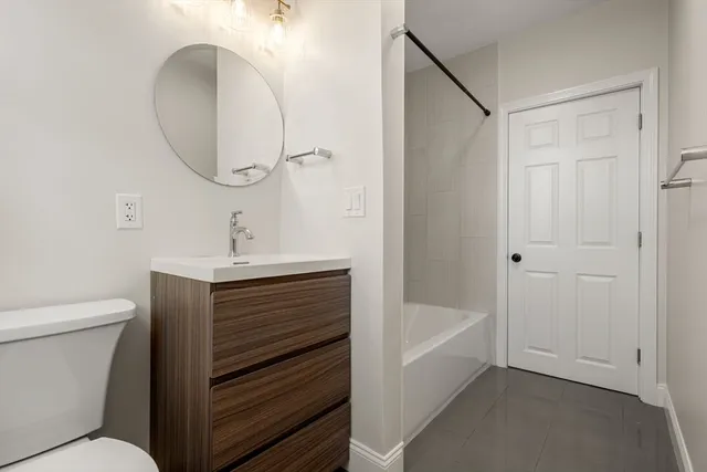 a white bath tub sitting next to a white toilet