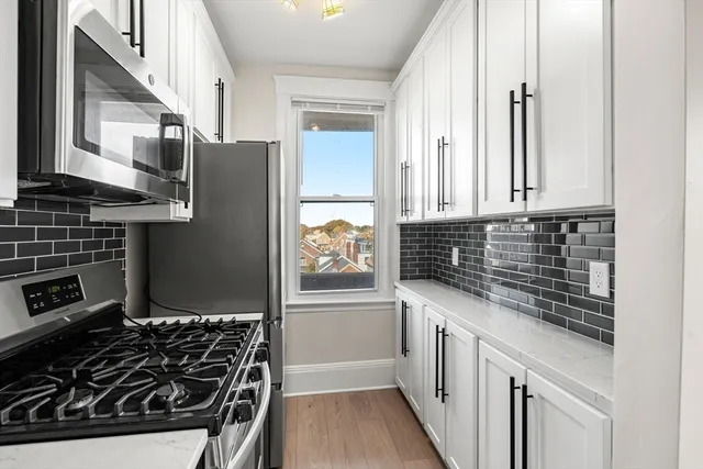 a kitchen with stainless steel appliances a stove and a refrigerator