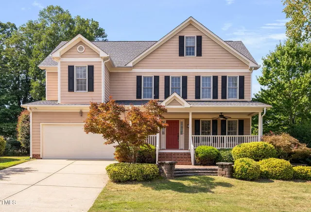 a front view of a house with a yard and garage