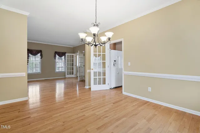 an empty room with a ceiling fan and window