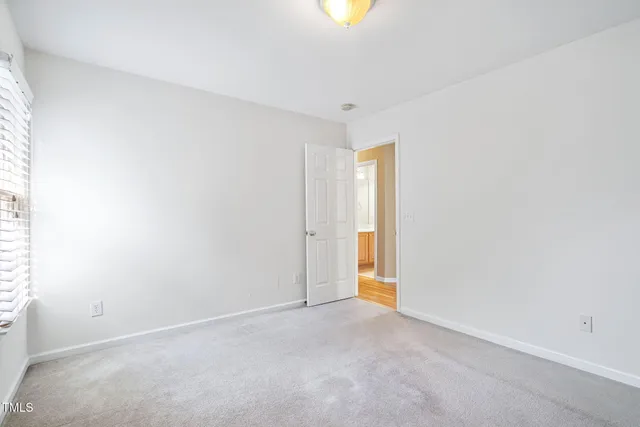 a front view of a house with a yard and potted plants