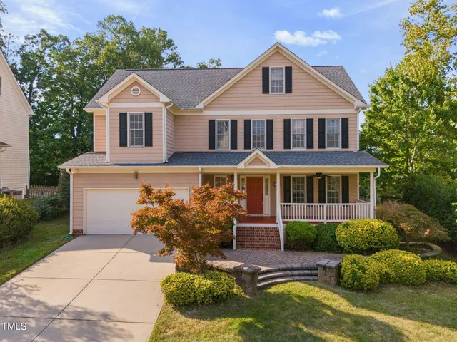a kitchen with stainless steel appliances granite countertop a stove a sink dishwasher a refrigerator and a oven with wooden floor