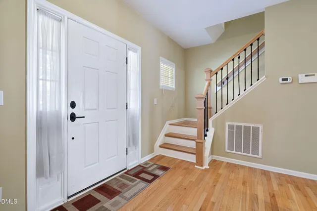 an empty room with a ceiling fan and window