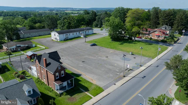 an aerial view of a house with swimming pool garden and patio