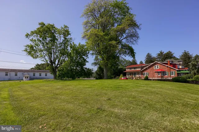a view of a big yard with a house in the background