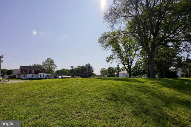 a view of a field of grass and trees