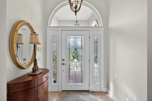 a living room with furniture or chandelier and a wooden floor