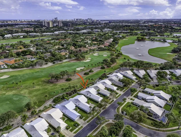an aerial view of a residential houses with outdoor space and a lake view