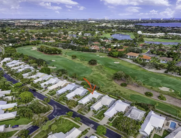 an aerial view of residential houses with outdoor space and street view