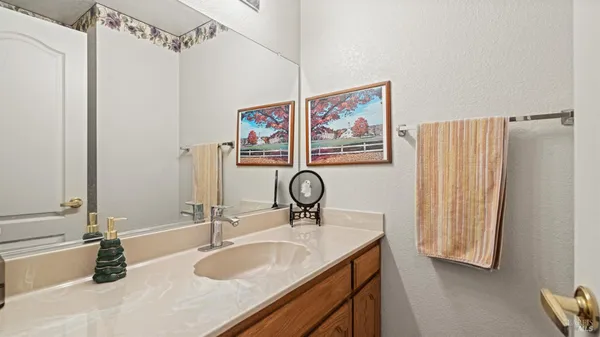 a living room with furniture a flat screen tv and a floor to ceiling window