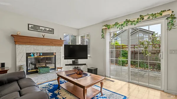 a living room with furniture a flat screen tv and a fireplace