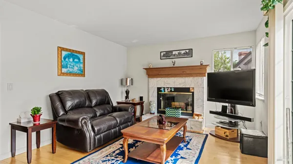 a kitchen with stainless steel appliances granite countertop a refrigerator a stove and a dining table