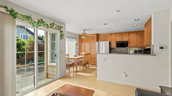 a kitchen with stainless steel appliances granite countertop a refrigerator sink and stove