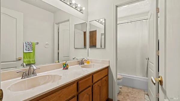 a bedroom with a bed and a refrigerator