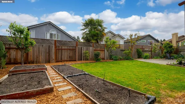 a view of backyard with deck and garden