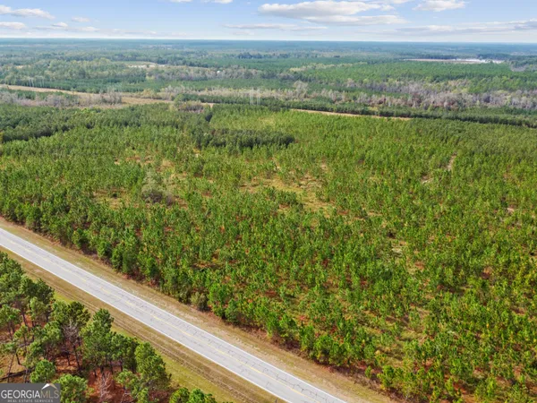 a view of a green field with an outdoor space