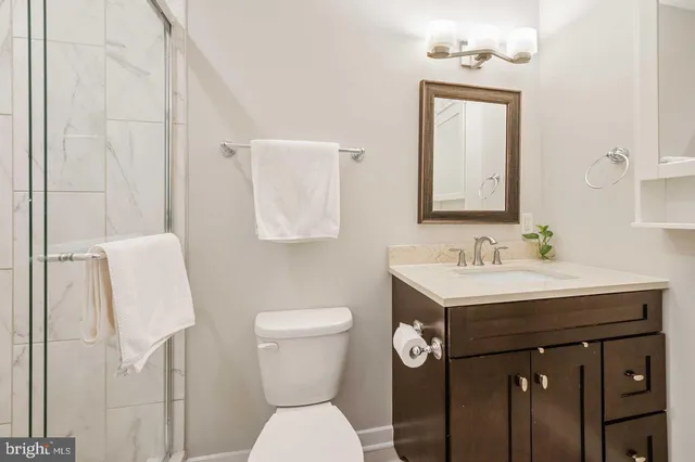 a bathroom with a sink toilet and mirror