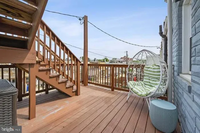 a view of balcony with wooden floor and seating