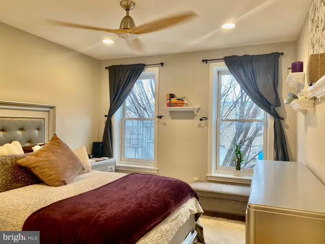 a bedroom with a bed and a window