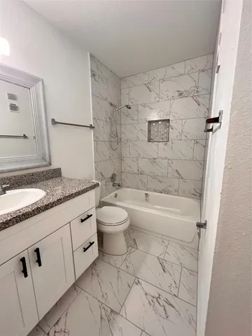 a bathroom with a toilet and a bathtub