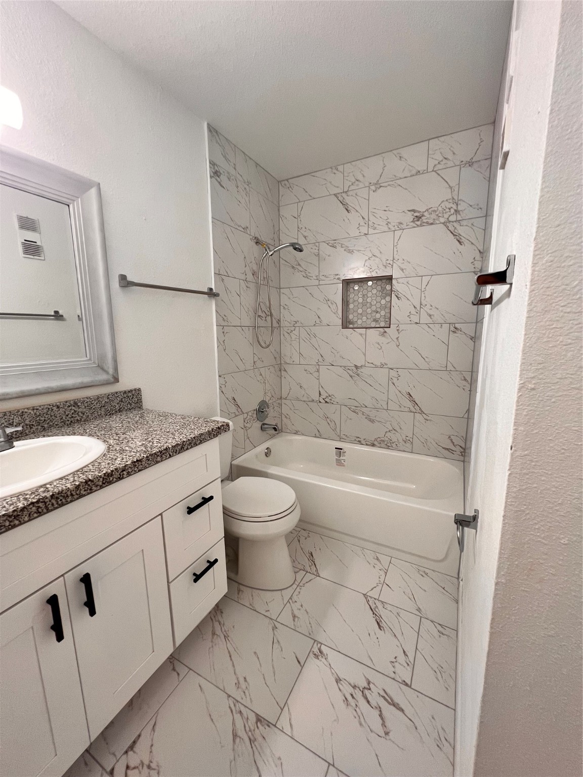 3005 Walnut Bend Lane, Unit 32 Houston, TX 77042 - Photo 13 of 26 a bathroom with a granite countertop sink a toilet and bathtub
