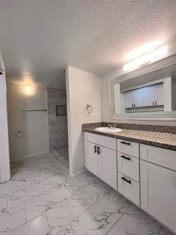 a bathroom with a bathtub and shower