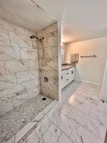 a view of a kitchen with white cabinets and wooden floor