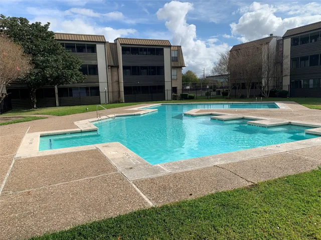 a front view of a house with swimming pool having outdoor seating