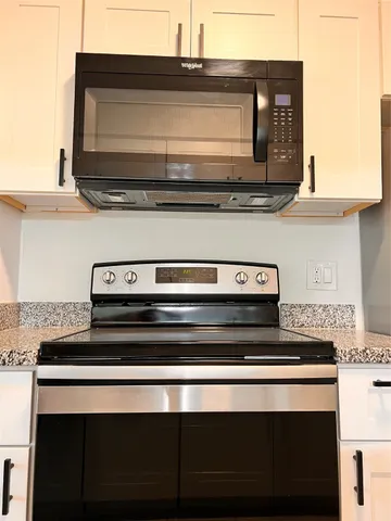 a stove top oven sitting inside of a kitchen