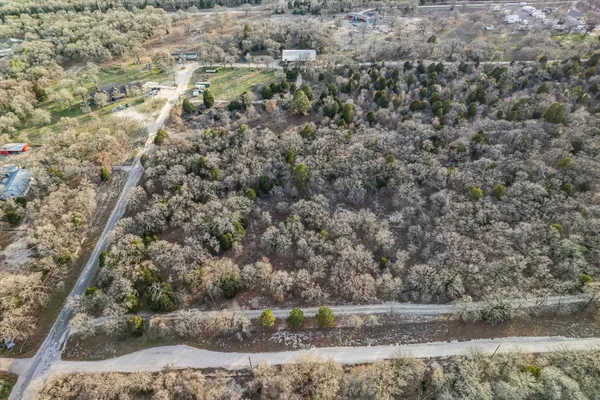a backyard of a house with a yard and large trees