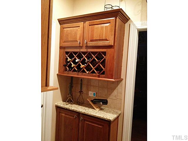 2504 Treen Street Raleigh, NC 27614 - Photo 12 of 13 Beautiful Butler's Pantry with granite counters, wine rack, cabinets, and bar.