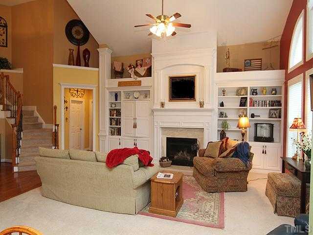 2504 Treen Street Raleigh, NC 27614 - Photo 6 of 13 2 story family room with gas log fireplace, built in bookshelves and lots of windows