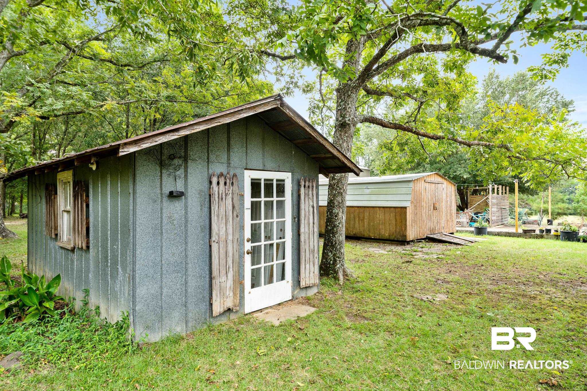 11528 Whitehouse Fork Road Bay Minette, AL 36507 - Photo 25 of 37 View of outbuilding featuring a lawn