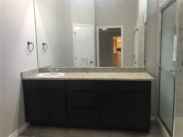 a bathroom with a shower and a sink