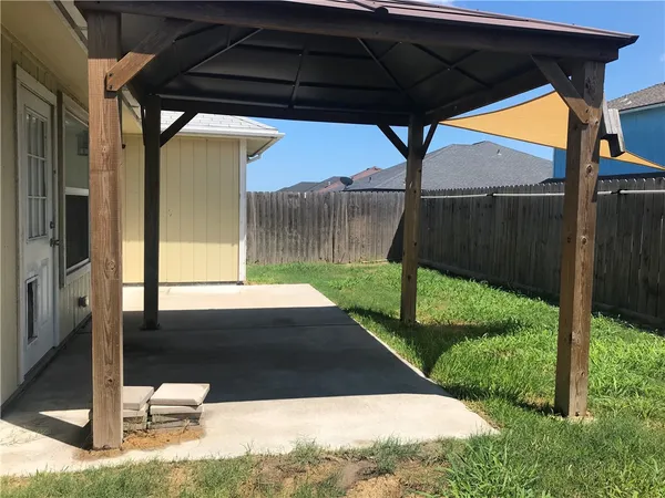 a backyard of a house with dishwasher and a yard