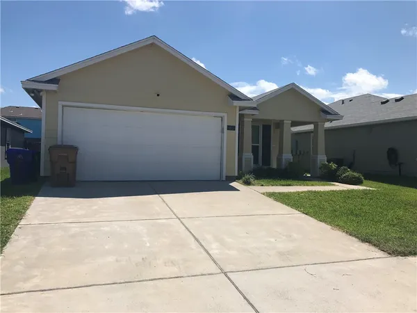 a view of backyard of house and garage