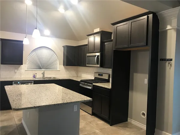 a kitchen with a sink and a microwave