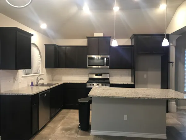 a kitchen with a sink and a microwave