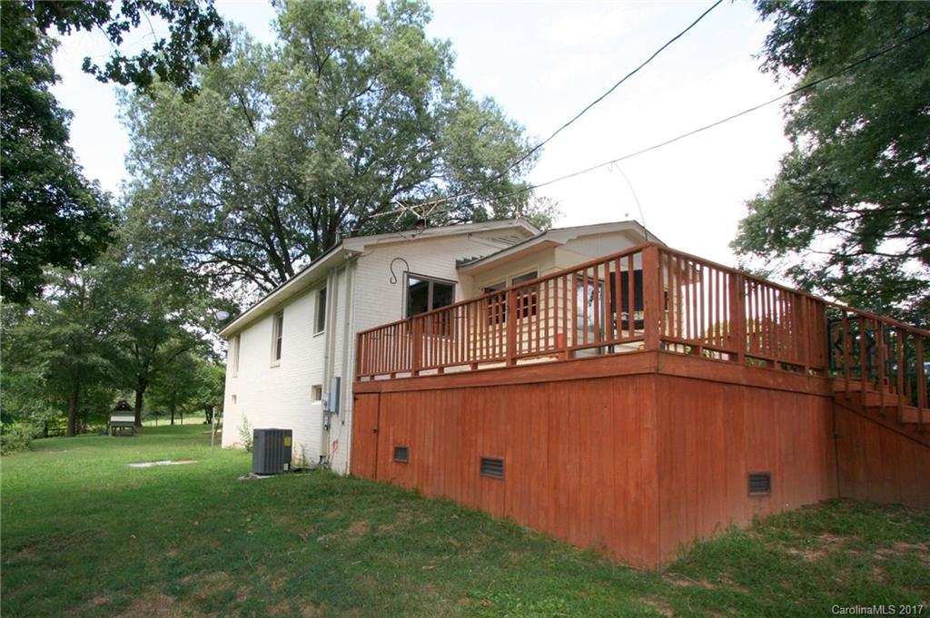 1406 Tomberlin Road, Unit 6 Monroe, NC 28110 - Photo 5 of 24 a backyard of a house with wooden fence and large trees