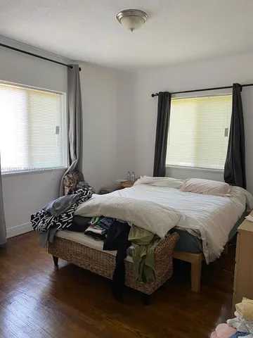 a bedroom with a bed and a window