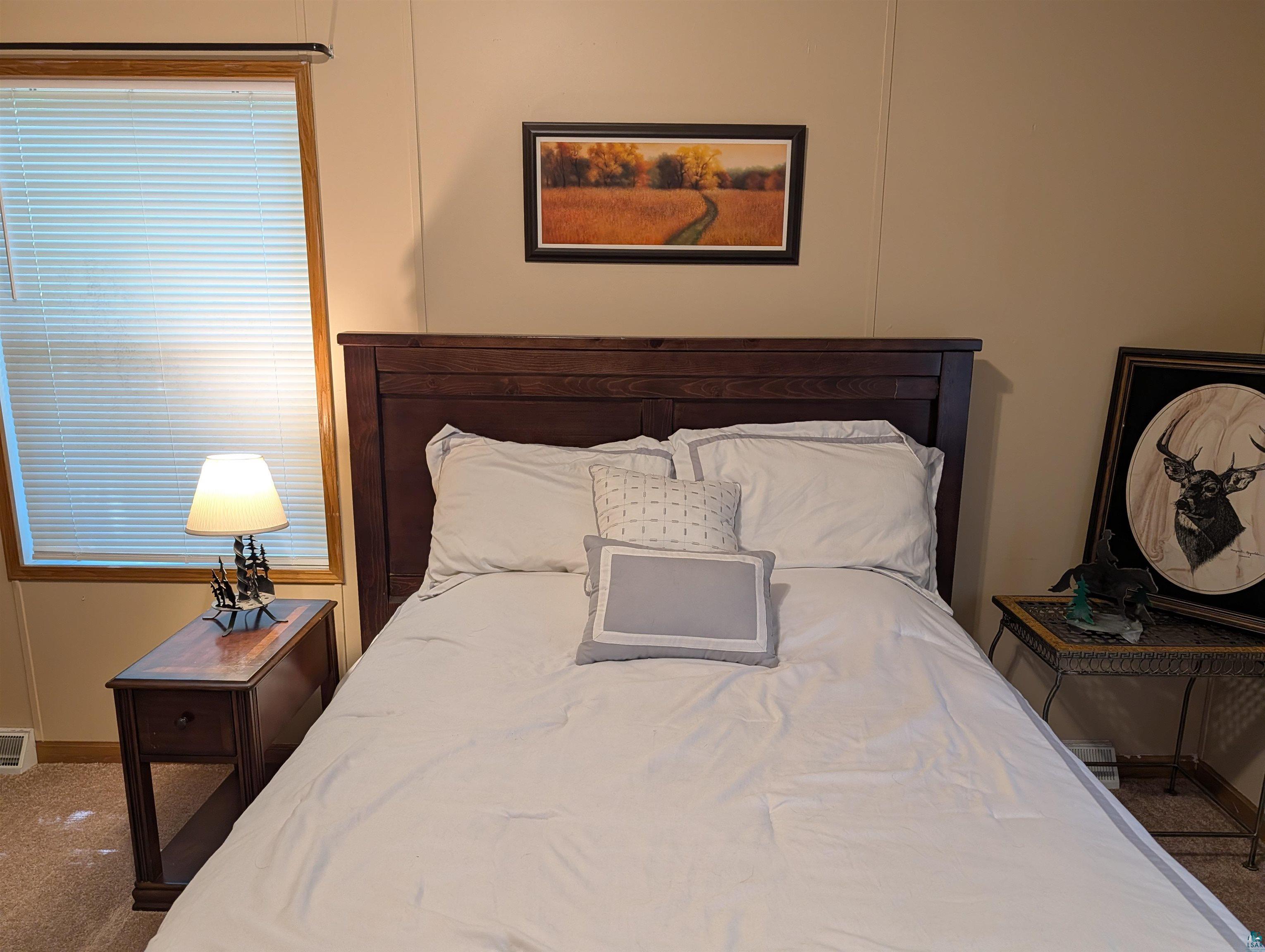 3945 Maple Street Kettle River, MN 55757 - Photo 25 of 41 Wood-finish headboard and frame with complementary wood-finish nightstand featuring a single drawer and lower shelf