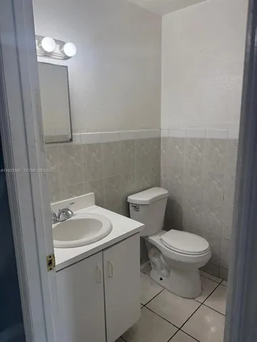 a white toilet sitting next to a bathroom sink