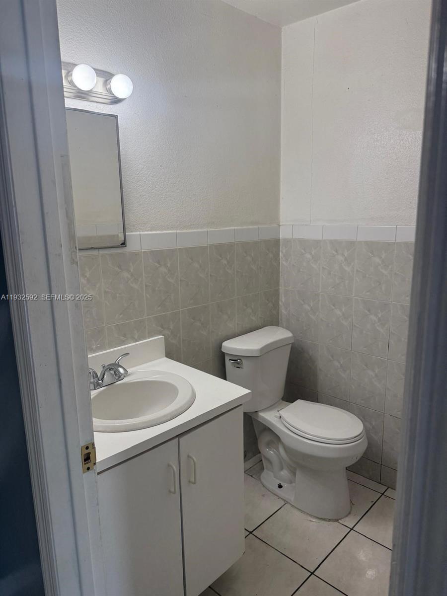 28144 Southwest 142nd Court Homestead, FL 33033 - Photo 3 of 12 a white toilet sitting next to a bathroom sink